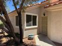 Close up shot of a home entrance featuring a security door, window, and desert landscaping at 7830 Foxwood Pl # 0, Las Vegas, NV 89145
