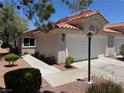 Attractive home featuring a two-car garage, desert landscaping, and a terracotta tile roof at 7830 Foxwood Pl # 0, Las Vegas, NV 89145