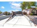 Long private driveway leading to a beautiful home with secure gate and lush landscaping at 786 Craigmark Ct, Henderson, NV 89002