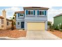 Charming two-story home with a blue exterior, blue shutters, desert-landscaped front yard, and a two-car garage at 8484 Montana Stream Ave, Las Vegas, NV 89113