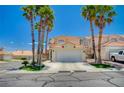 Inviting two-story home with a spacious driveway, lush landscaping, and mature palm trees at 8953 Paige Rene Ct, Las Vegas, NV 89117