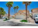 Well-maintained home with a two-car garage, neatly landscaped yard, and mature palm trees at 8953 Paige Rene Ct, Las Vegas, NV 89117