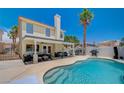 Inviting backyard featuring a private pool, covered patio, and comfortable seating area for relaxation at 8953 Paige Rene Ct, Las Vegas, NV 89117