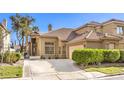 Attractive single-Gathering house showcasing a well-manicured yard and a two-car garage at 9220 Pitching Wedge Dr, Las Vegas, NV 89134