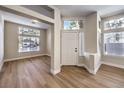Inviting foyer with wood-look floors, bright windows, and a stylish front door at 9220 Pitching Wedge Dr, Las Vegas, NV 89134