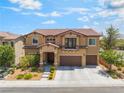 Beautiful two-story home featuring a tile roof, balcony, three-car garage and well-manicured landscaping at 9635 Ramon Valley Ave, Las Vegas, NV 89149