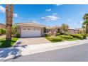 Inviting home with a wide driveway, spacious two-car garage and manicured landscaping at 10331 Rio De Thule Ln, Las Vegas, NV 89135