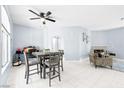 Open-concept living space with dining table and chairs, fireplace, and neutral decor at 109 Breezy Tree Ct # 202, Las Vegas, NV 89145