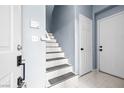 Hall with staircase leading upstairs, featuring white risers and grey carpeted treads at 109 Breezy Tree Ct # 202, Las Vegas, NV 89145