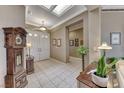 Spacious foyer with tile flooring, skylights, an antique clock, and neutral-colored walls at 1641 Rockcrest Hills Ave, Henderson, NV 89052