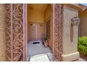 Charming front entrance featuring decorative ironwork and a welcoming double door at 1641 Rockcrest Hills Ave, Henderson, NV 89052