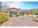 Beautiful single-story home featuring desert landscaping and a well-maintained front yard at 1641 Rockcrest Hills Ave, Henderson, NV 89052