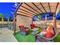 Comfortable outdoor living space with covered seating, and landscaped surroundings at 1717 Jake Andrew Ave, North Las Vegas, NV 89086