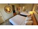 Bright bedroom featuring two queen beds with fresh white linens and comfortable decor at 211 E Flamingo Rd # 405, Las Vegas, NV 89169
