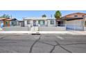 Charming single-story home featuring a block wall and decorative iron fencing for added curb appeal and security at 2313 Van Patten Pl, Las Vegas, NV 89104