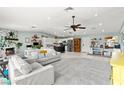 Bright, spacious living area featuring an open floor plan with modern decor, a fireplace, and seamless flow into the kitchen at 2426 La Pluma St, Henderson, NV 89014