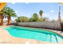Refreshing private pool surrounded by lush greenery and a secure fence, perfect for relaxing or entertaining guests at 2426 La Pluma St, Henderson, NV 89014