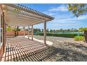 Enjoy outdoor living on this covered patio with views of the lake and lush landscaping at 2537 Seascape Dr, Las Vegas, NV 89128