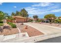 Inviting single-story home boasting well-maintained landscaping, a circular driveway, and a two-car garage at 2537 Seascape Dr, Las Vegas, NV 89128