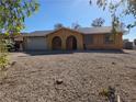 Single-story home with gravel landscaping, two-car garage, and arched entryway at 256 Winona Ter, Henderson, NV 89015