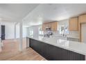 Open-concept kitchen boasts a large island, stainless steel appliances, and sleek light wood cabinetry at 2611 Siesta Ave, Las Vegas, NV 89121