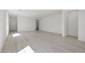 Spacious living room with light wood floors and ample natural light at 2612 Lily Point St, Las Vegas, NV 89156