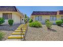 Exterior view of a well-maintained home with tidy landscaping and a walkway with yellow steps at 2732 Heritage Ct, Las Vegas, NV 89121