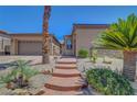 Inviting front of home with desert landscaping, neutral color scheme, and covered porch at 2779 Kindeace Ave, Henderson, NV 89044