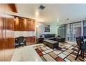 Bright living room featuring a comfortable sofa, stylish decor, and a built-in workspace at 3111 Bel Air Dr # 201, Las Vegas, NV 89109
