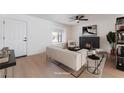 The staged living room is cozy with a fireplace, and comfortable furnishings at 313 Agora Way, Las Vegas, NV 89110