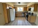 Well-lit kitchen features stainless steel appliances, granite countertops, and wood cabinets with ample storage at 3412 Mercury St # I, North Las Vegas, NV 89030