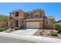 Two-story home featuring stone accents, a two-car garage, and well-maintained landscaping at 3609 Kingfishers Catch Ave, North Las Vegas, NV 89084