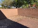 A private patio area features a brick floor and a rock garden at 3813 Juanita May Ave, North Las Vegas, NV 89032