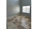 Bright bedroom showcasing tile flooring and a window with neighborhood views at 3941 Copper Stone Ct, North Las Vegas, NV 89032