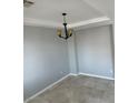 Cozy living room with modern lighting fixture, tile flooring, and neutral walls at 3941 Copper Stone Ct, North Las Vegas, NV 89032