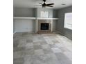 Spacious living room with a fireplace, built-ins, tile flooring, and natural light at 3941 Copper Stone Ct, North Las Vegas, NV 89032