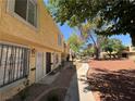 Side view of exterior showing walkway with garden featuring well maintained plants and bushes at 453 Las Casitas Way, Las Vegas, NV 89121