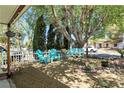 Relaxing front yard featuring mature trees, a comfortable swing, and seating, perfect for enjoying the outdoors at 517 5Th St, Boulder City, NV 89005