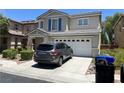 Inviting two-story home with a two-car garage and a beautifully landscaped front yard at 5824 Gemstone Peak St, North Las Vegas, NV 89031