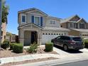 Attractive two-story house with a well-maintained lawn and a convenient two-car garage at 5824 Gemstone Peak St, North Las Vegas, NV 89031