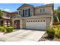 Charming two-story home featuring an attached two car garage and driveway at 5824 Gemstone Peak St, North Las Vegas, NV 89031