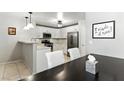 Bright kitchen featuring white cabinetry, stainless appliances, and adjacent dining area at 620 Painted Cloud Pl, Las Vegas, NV 89144