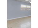 Bright living room with light gray walls and lovely laminate wood flooring at 6317 Alta Dr, Las Vegas, NV 89107