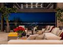 Modern living room with chic furniture, plants and expansive windows showcasing panoramic Las Vegas city views at 720 Dragon Peak Dr, Henderson, NV 89012