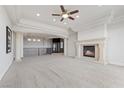 Spacious living room boasting high ceilings, a cozy fireplace, and elevator access to the upper floor at 73 Kittansett Loop, Henderson, NV 89052