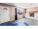 View of living room with fireplace, concrete floors, and a white front door at 805 E Carey Ave, North Las Vegas, NV 89030