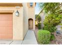 Charming home exterior showcasing a tidy walkway and manicured landscaping leading to the front door at 8930 W Ford Ave, Las Vegas, NV 89148