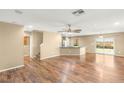 Open-concept living room featuring hardwood floors, a ceiling fan, and backyard access at 8930 W Ford Ave, Las Vegas, NV 89148