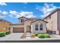 Charming stucco home featuring a two-car garage, landscaped front yard, and tile roof at 9131 Grand Sunburst Ct, Las Vegas, NV 89149