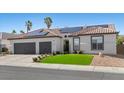 Charming home featuring a two-car garage, tile roof, solar panels, and well-manicured lawn at 9612 Glengarry Dr, Las Vegas, NV 89129